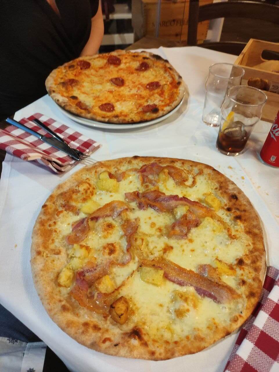 Two Pizzas one with pepperoni/salame and another custom one